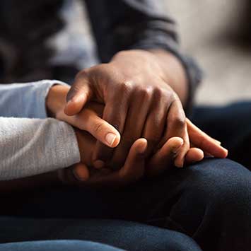 A couple holding hands while working out pre-nuptial agreements in Walnut Creek, CA